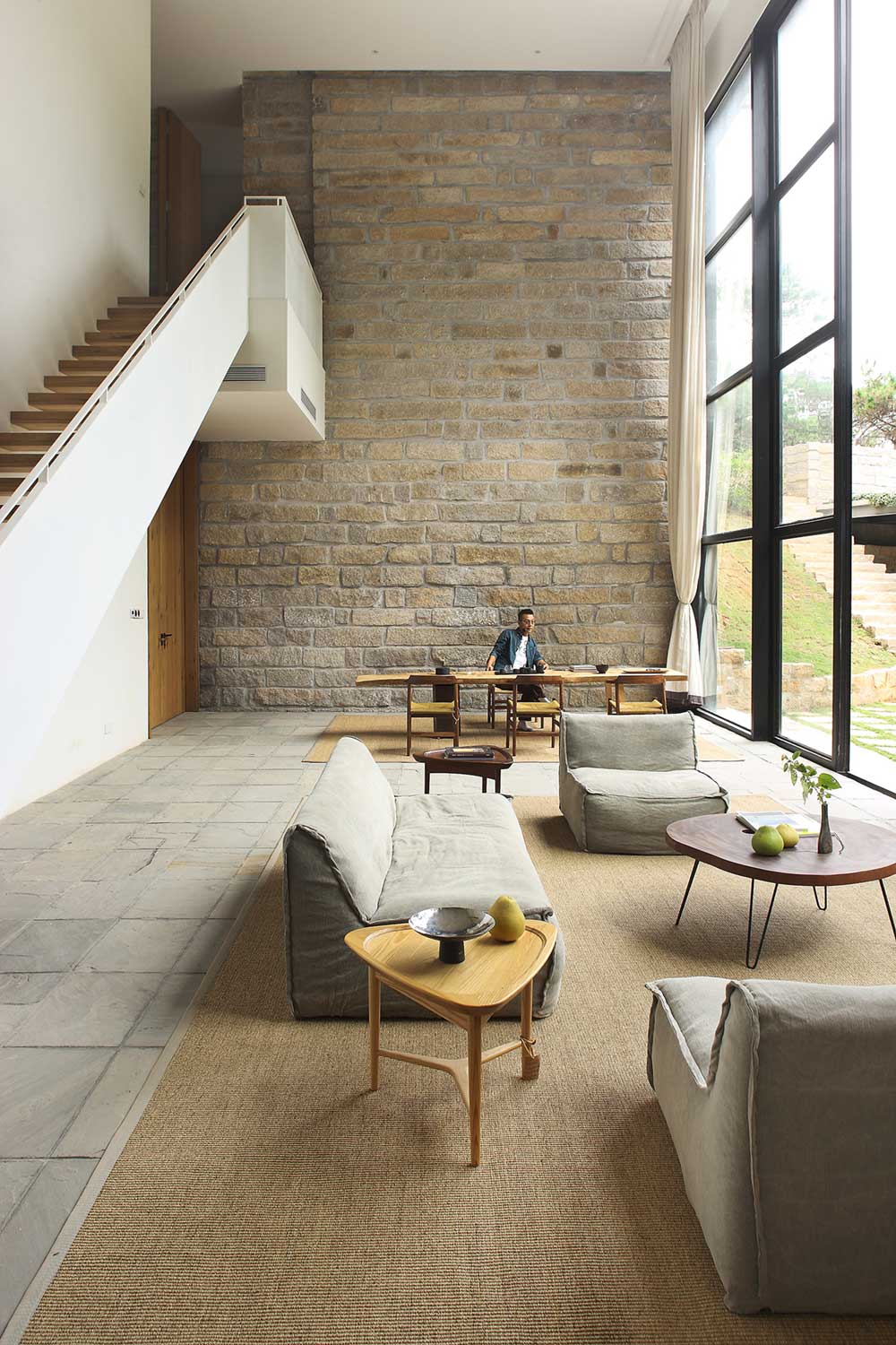 Double Height Living Room with Brick Wall