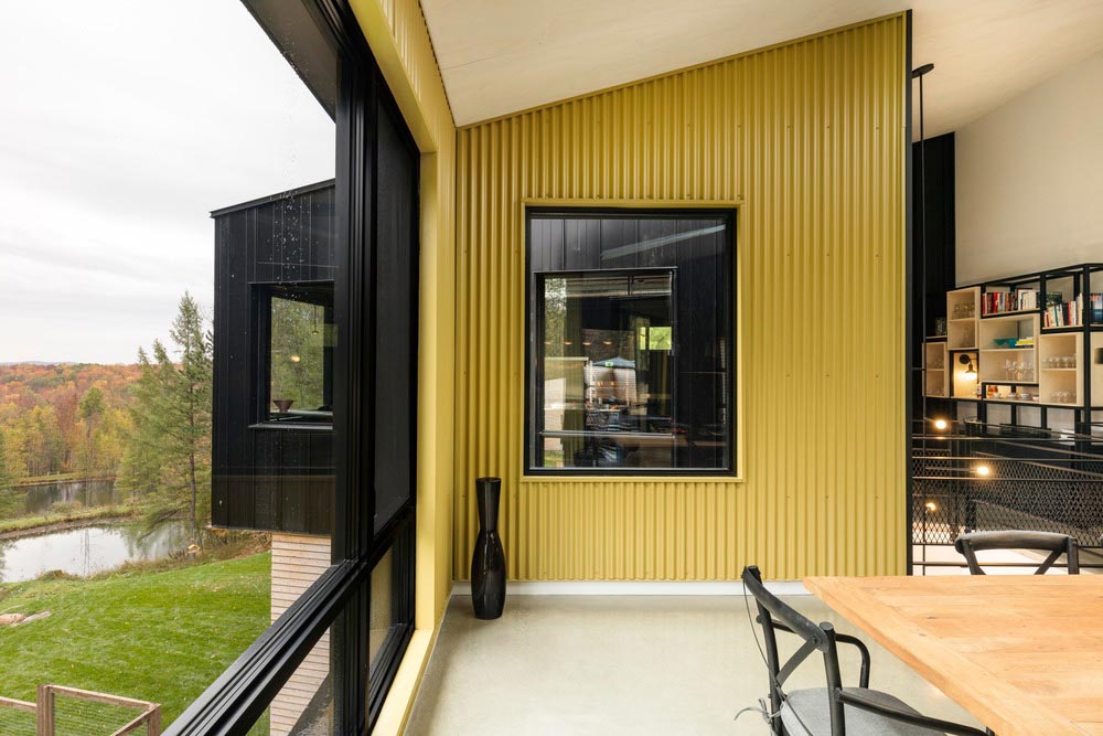 hillside home yellow wall design tux - Abercorn Chalet