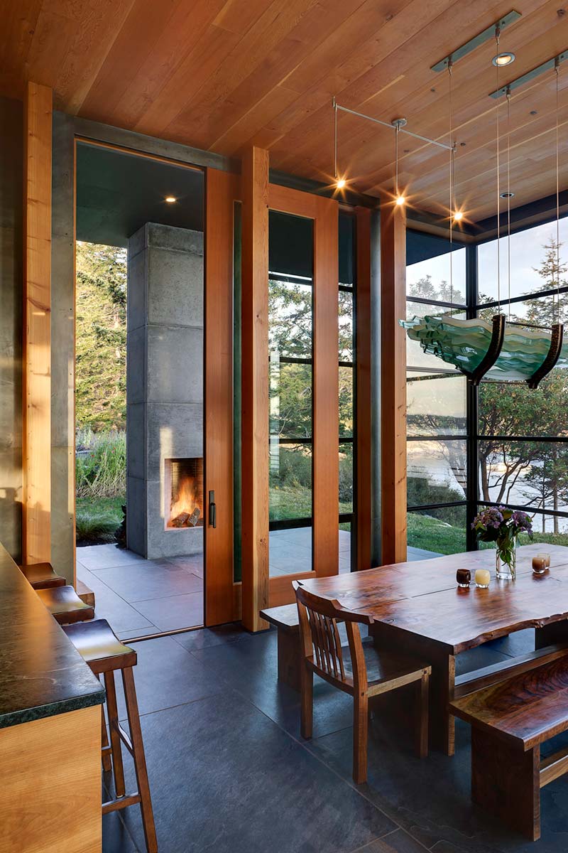 modern island cabin outdoor fireplace - North Bay Residence