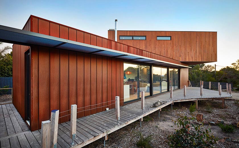 Clad prefab home with wooden deck