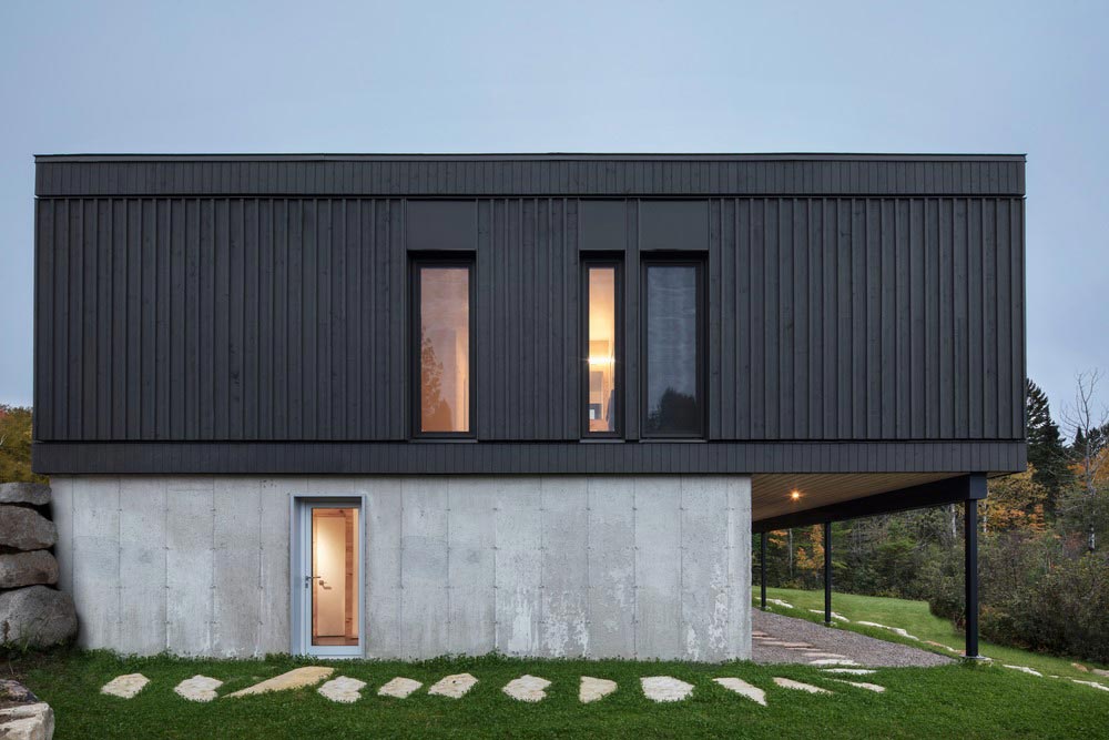 wood concrete lake house design side - La Barque Residence