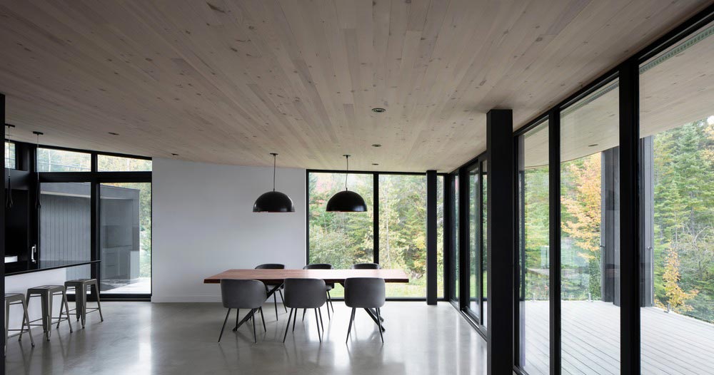 wood concrete lake house dining design - La Barque Residence